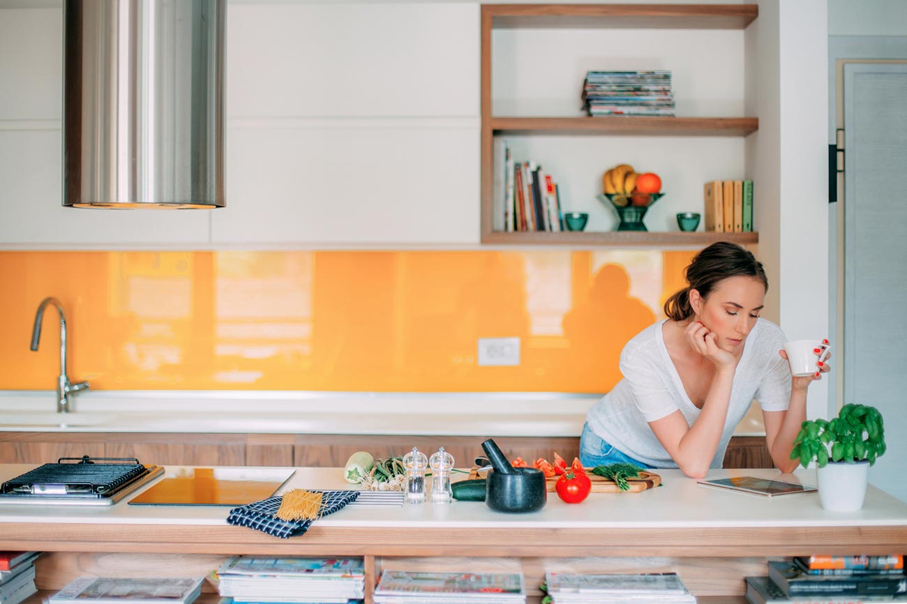 Woman reading in her kitchen