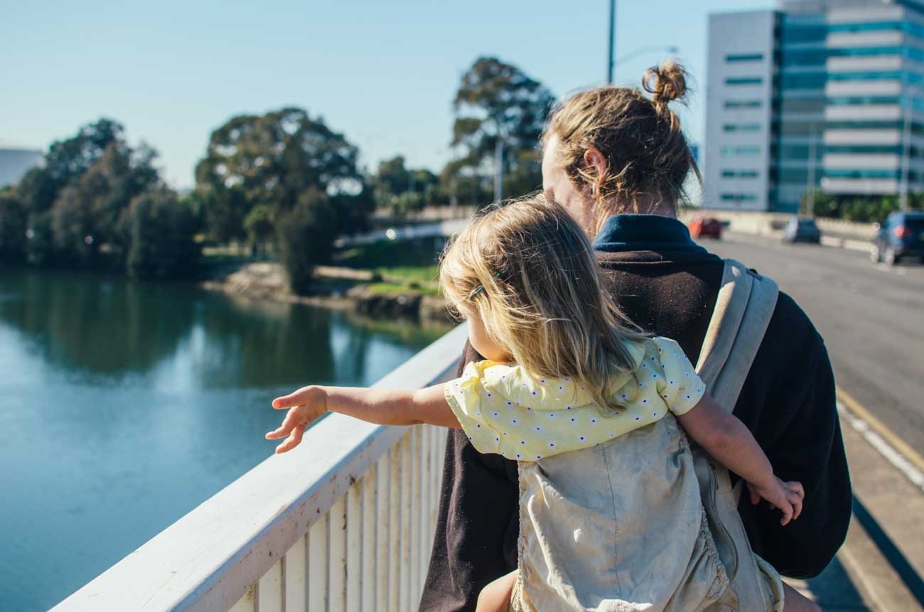 Father and daughter in the city overlooking the river