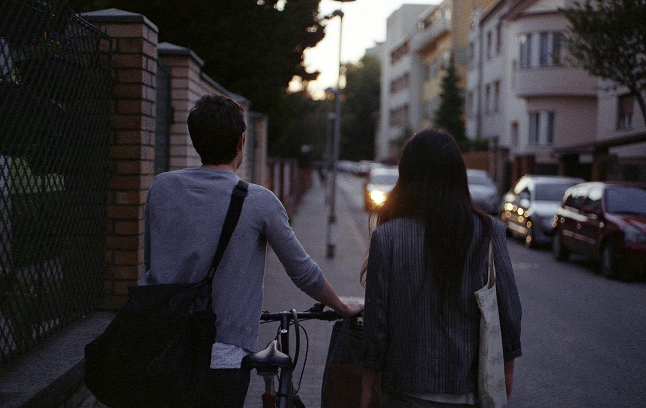 Couple on the street with a bike