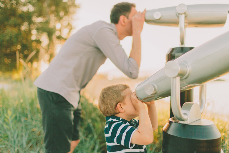 father and son on telescopes
